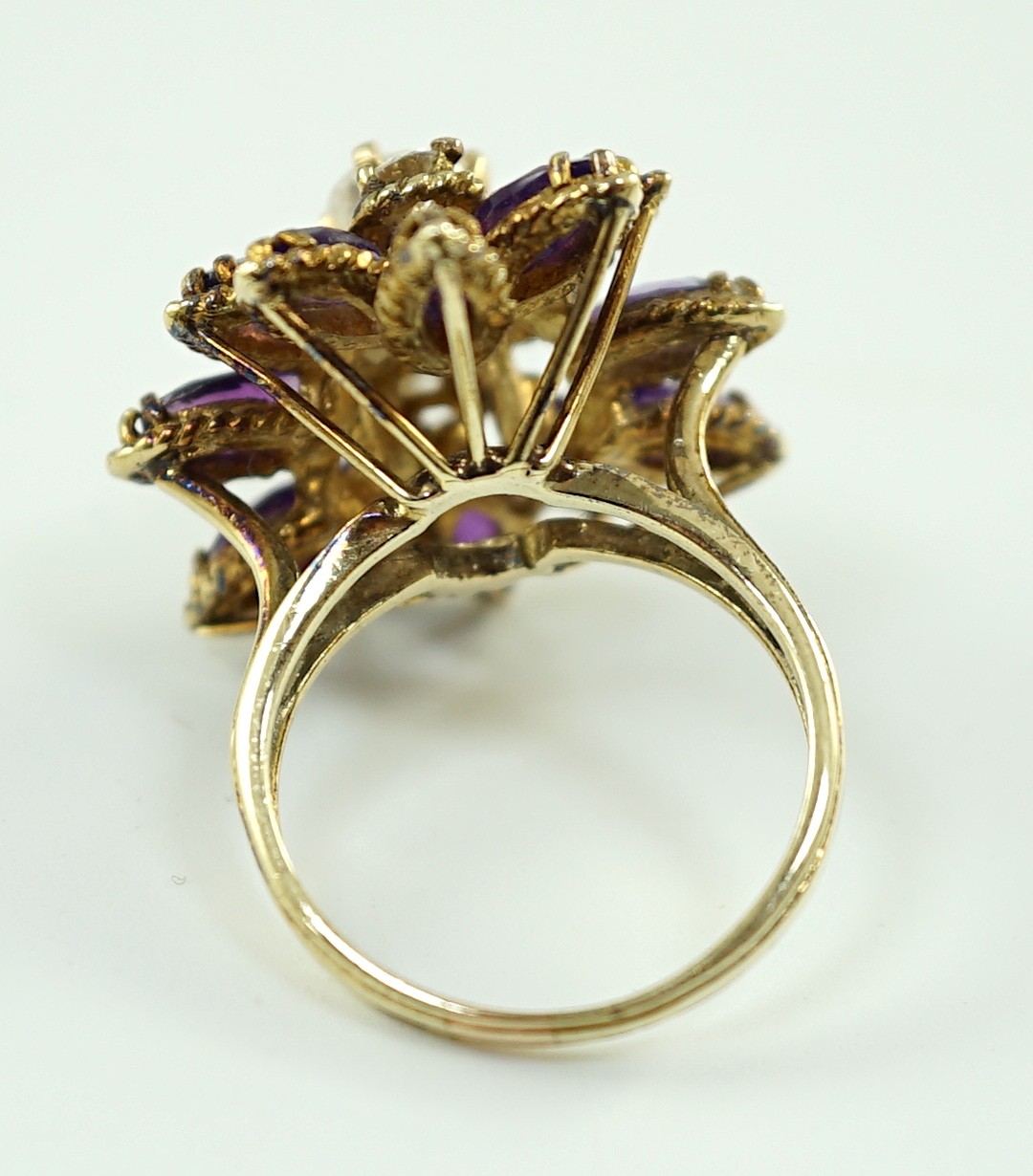 A 14k gold, five stone graduated round cut diamond and twelve stone marquise cut amethyst set cluster dress ring
